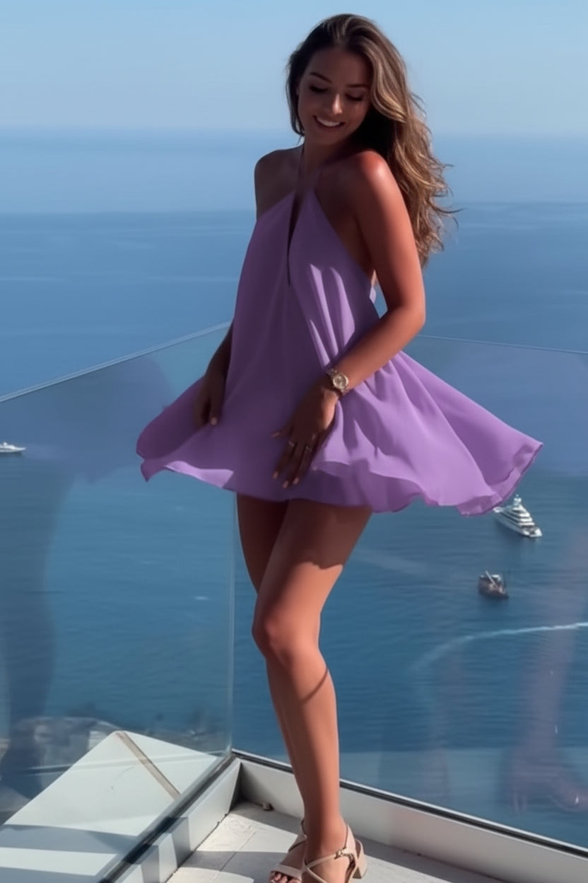 Woman in a purple dress standing on a balcony with a blue sea and sky background