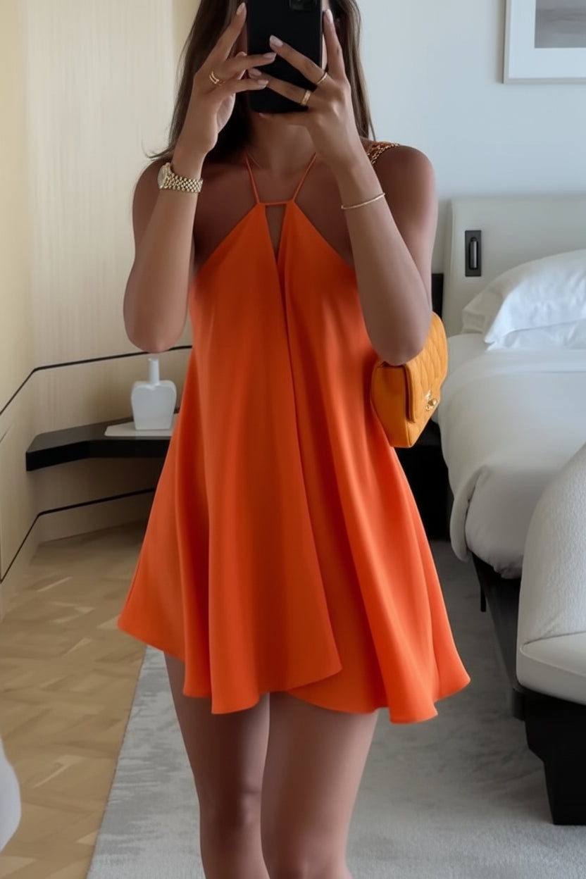 Person wearing an orange dress in a bedroom setting